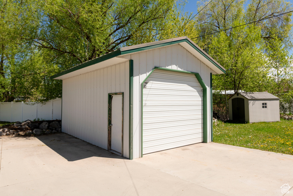Detached garage featuring fence