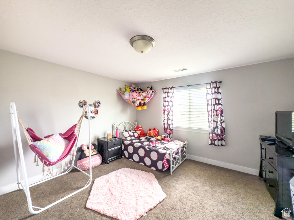 Carpeted bedroom featuring baseboards