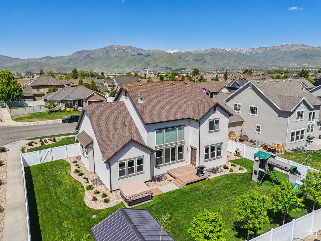 Aerial perspective of suburban area featuring a mountain backdrop
