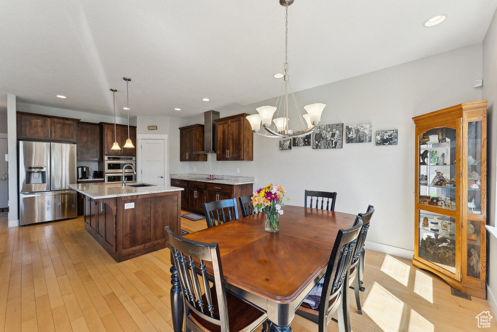 Dining room featuring a chandelier, light wood-type flooring, and recessed lighting