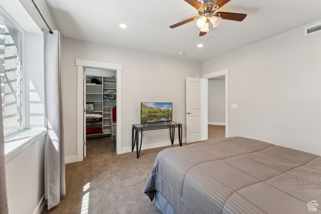 Bedroom featuring a spacious closet, carpet flooring, a closet, recessed lighting, and ceiling fan