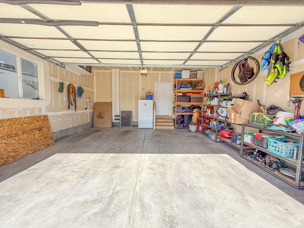 Garage featuring freestanding refrigerator