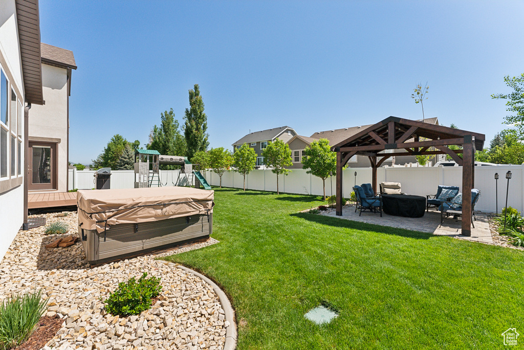 View of yard with a gazebo, a hot tub, a patio, and an outdoor living space