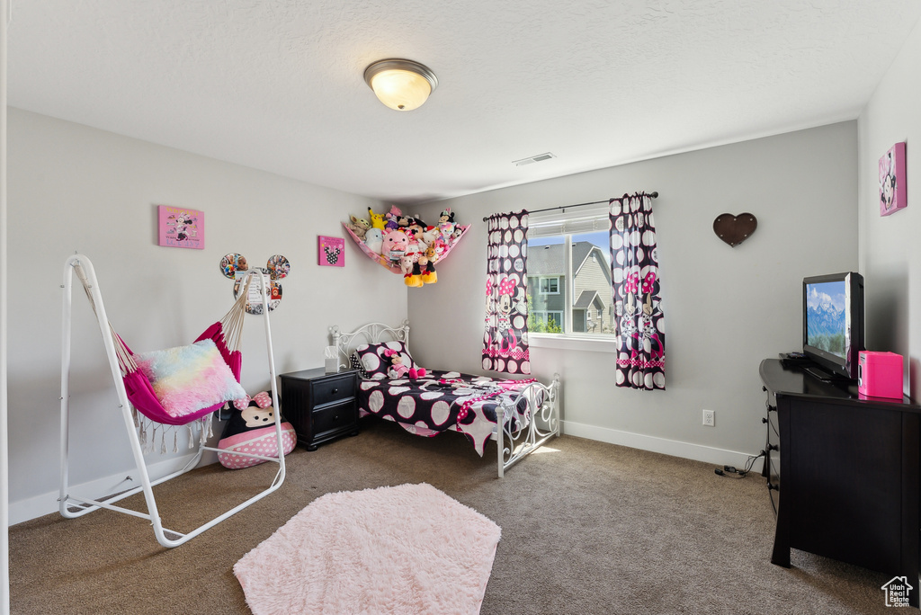 Bedroom with carpet flooring and baseboards