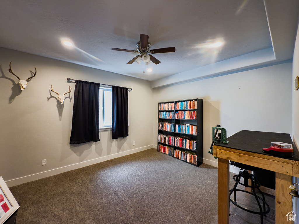 Carpeted office with a ceiling fan, baseboards, and recessed lighting