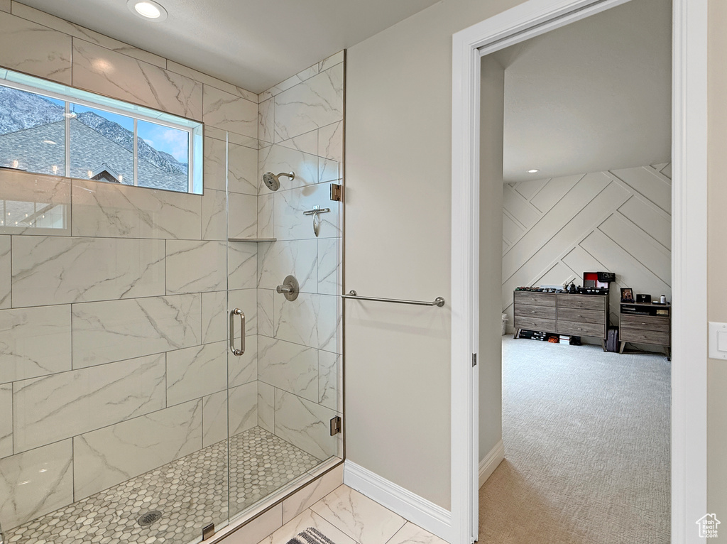 Bathroom with a shower stall, marble look tiles, baseboards, and recessed lighting
