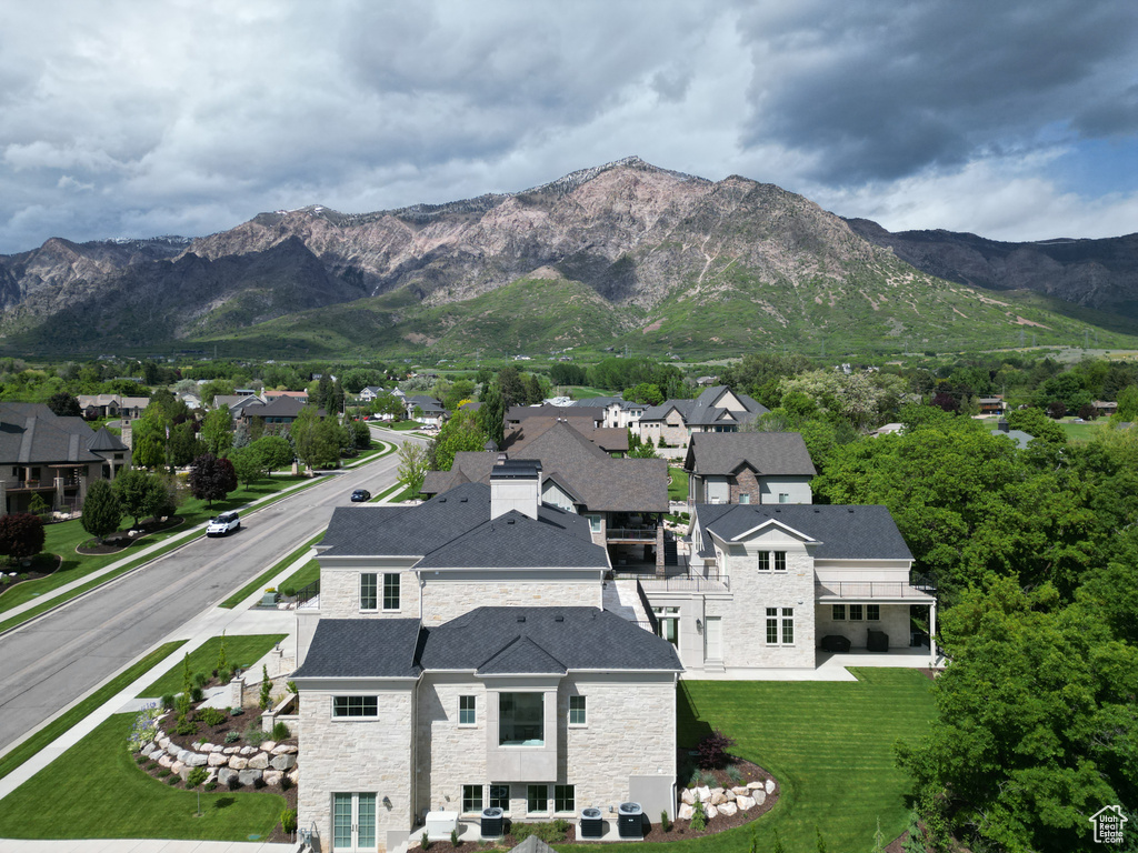 View of mountain backdrop featuring nearby suburban area