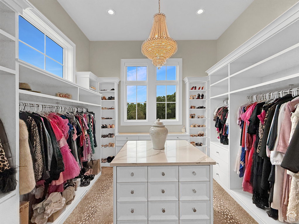Walk in closet with a chandelier