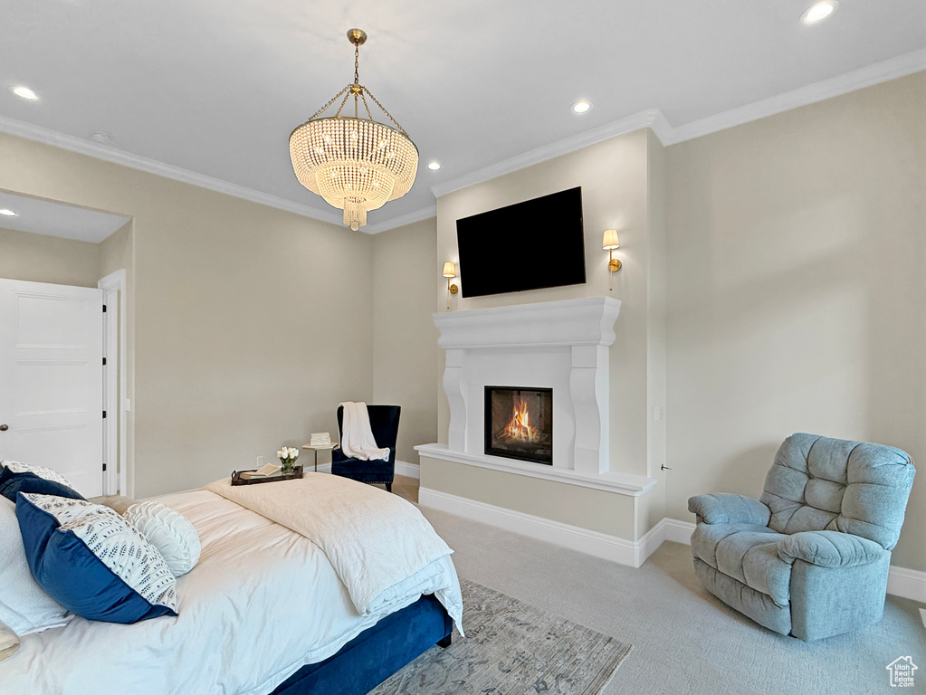Carpeted bedroom with recessed lighting, a glass covered fireplace, crown molding, baseboards, and a chandelier