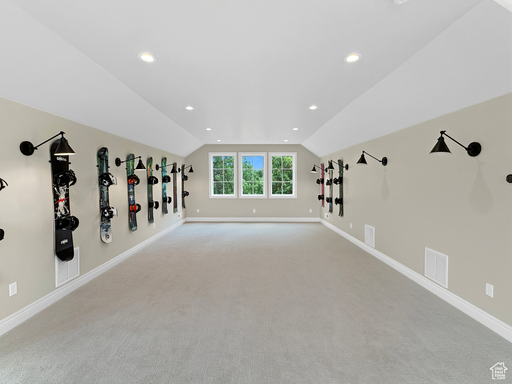 Additional living space with vaulted ceiling, carpet flooring, baseboards, and recessed lighting