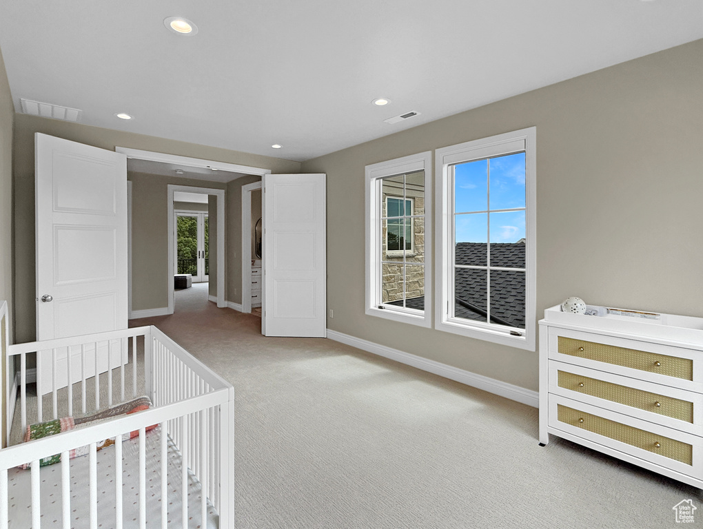 Unfurnished bedroom featuring light colored carpet, baseboards, and recessed lighting