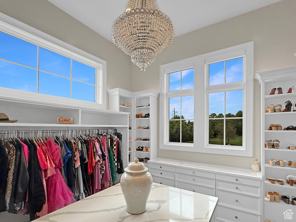 Spacious closet featuring a chandelier