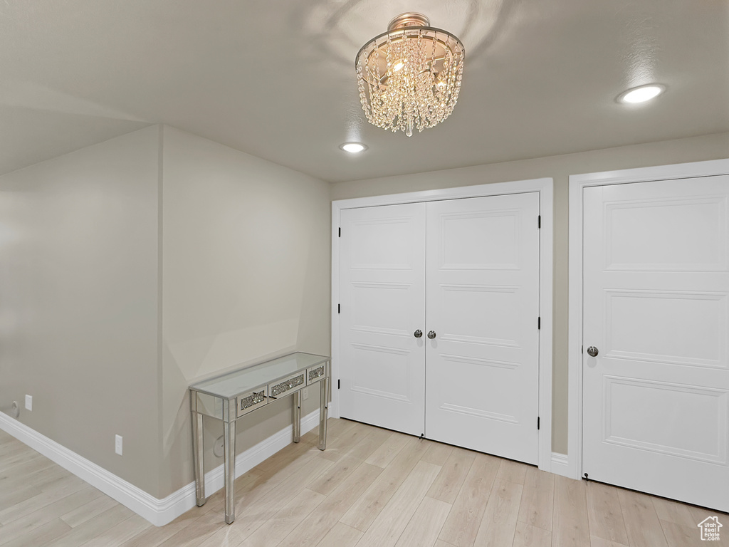 Entrance foyer featuring light wood-style flooring, a chandelier, recessed lighting, and baseboards
