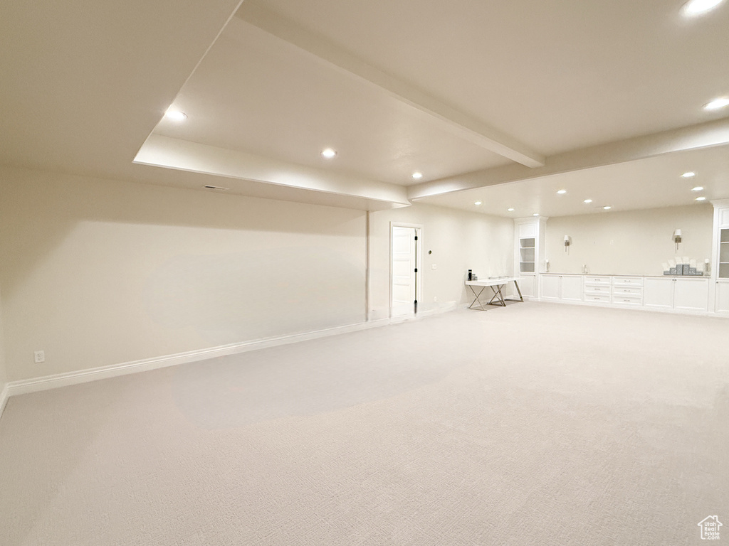 Finished below grade area featuring recessed lighting, wet bar, light colored carpet, and baseboards