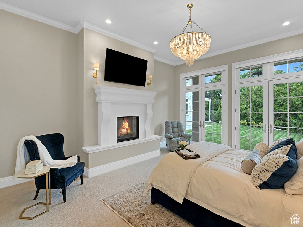 Carpeted bedroom featuring access to outside, multiple windows, recessed lighting, french doors, and ornamental molding