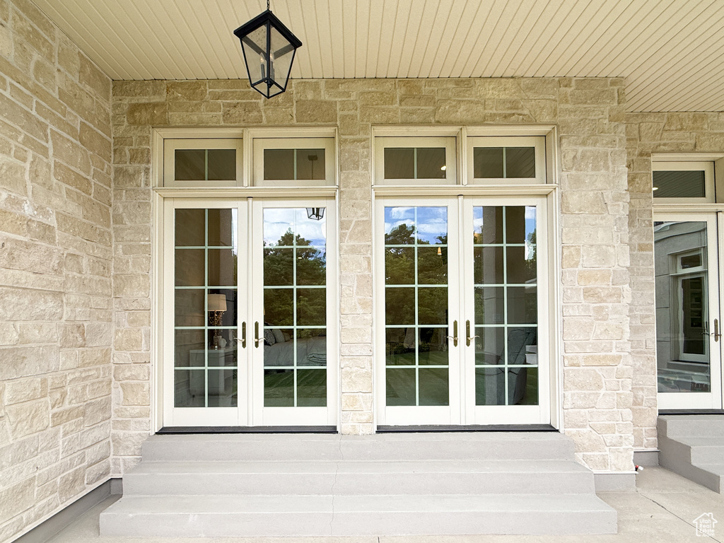 Property entrance featuring french doors and stone siding