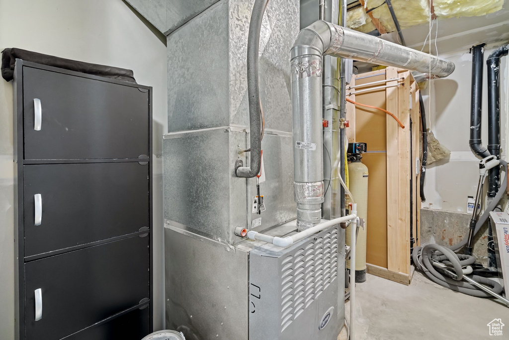 Utility room featuring heating unit