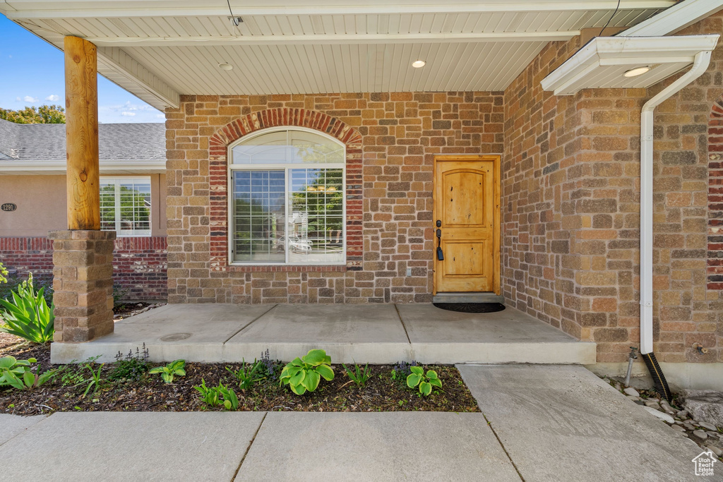 Doorway to property featuring brick siding
