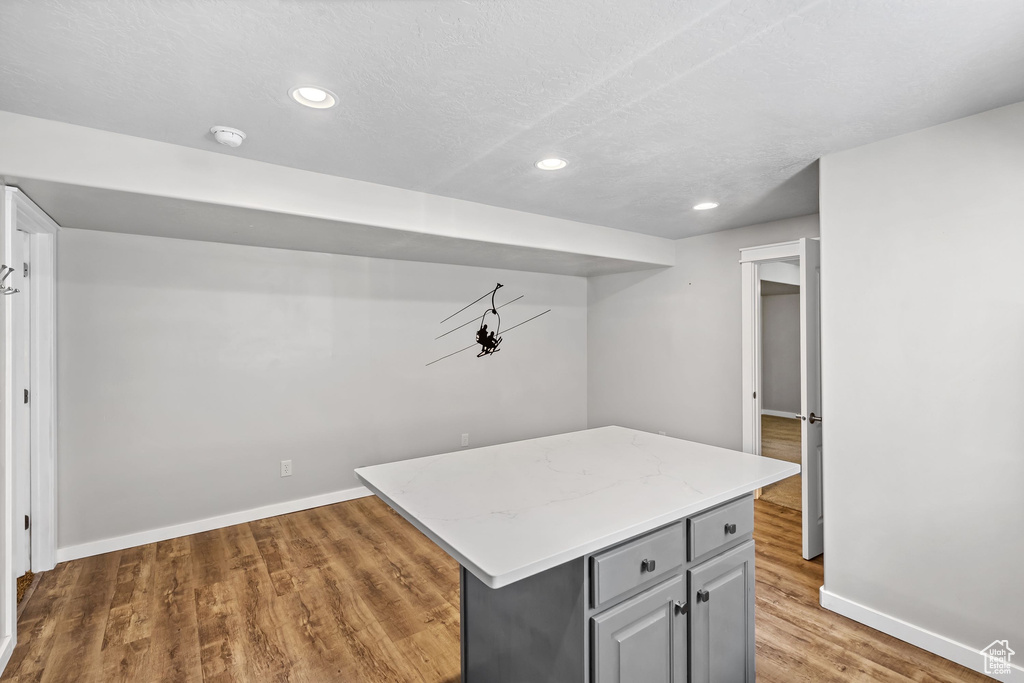 Finished basement with baseboards, wood finished floors, and recessed lighting