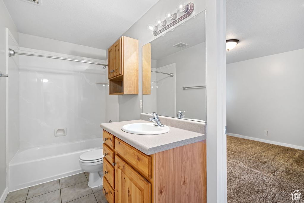 Full bathroom with vanity, toilet, bathing tub / shower combination, and tile patterned flooring