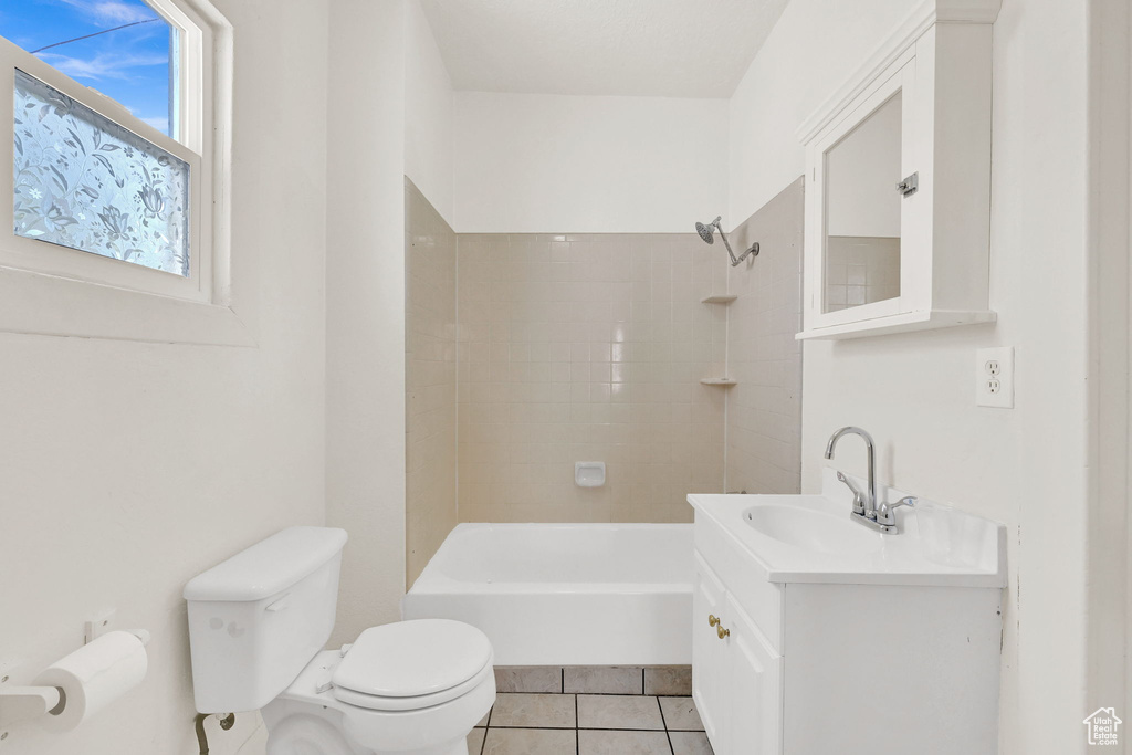 Full bath with toilet, vanity, tile patterned floors, and bathing tub / shower combination