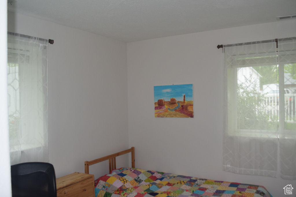 Bedroom with multiple windows