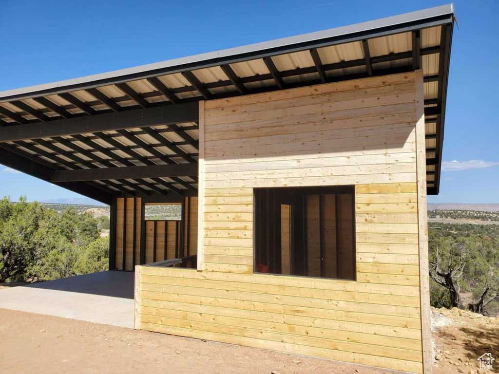 View of property exterior featuring an outdoor structure and an exterior structure