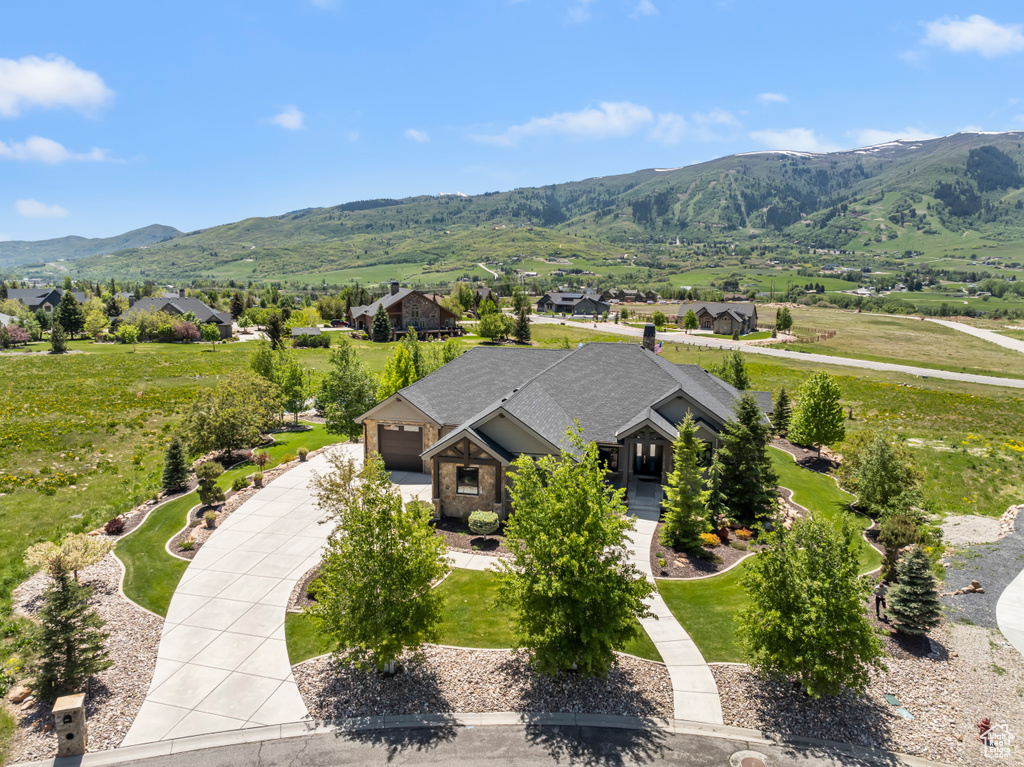 Aerial view of property and surrounding area with mountains