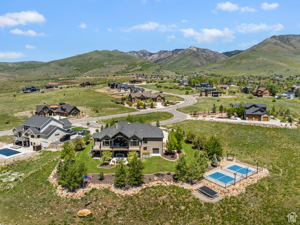 View from above of property with a pool area and a mountain backdrop