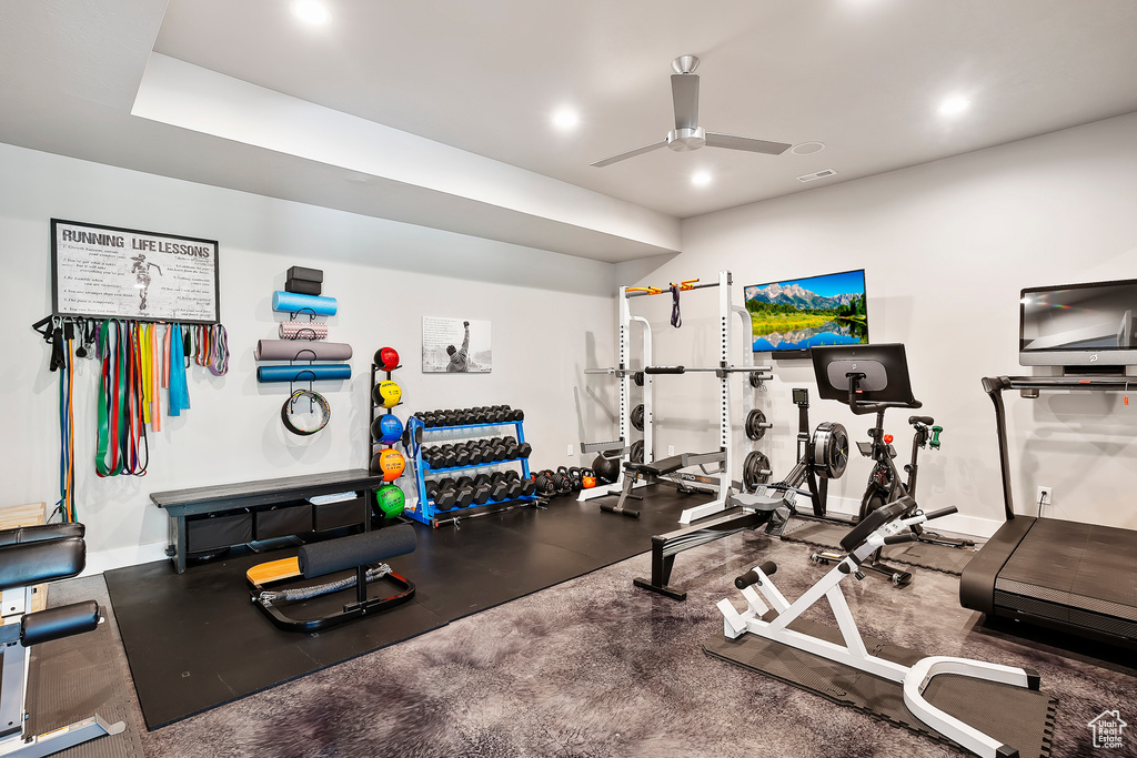 Exercise room with a ceiling fan, recessed lighting, and baseboards
