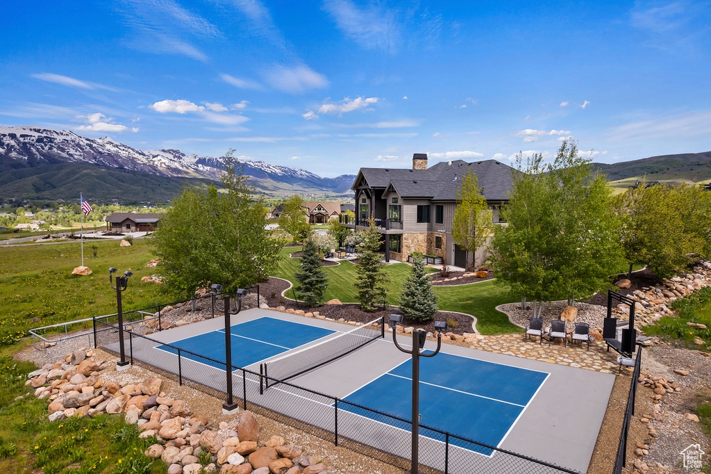 View of swimming pool featuring a tennis court and a mountain view