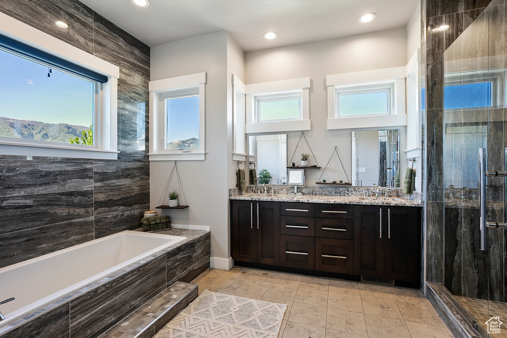 Full bath featuring a garden tub, double vanity, a shower stall, recessed lighting, and tile patterned flooring