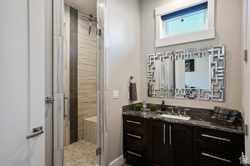 Full bathroom with vanity and a shower stall