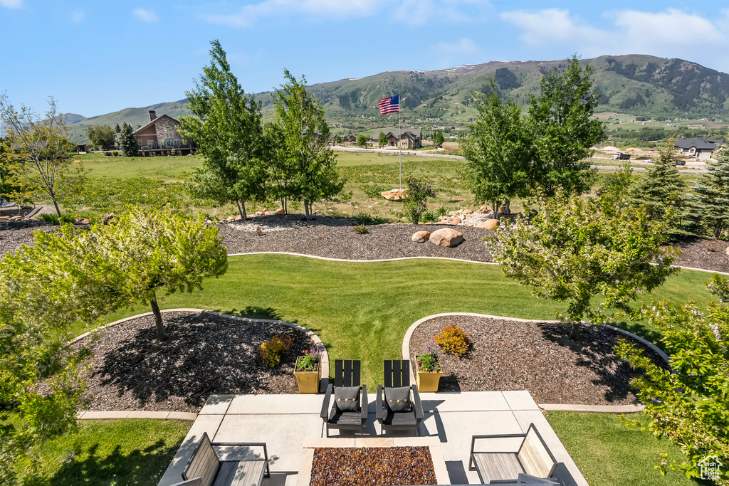 View of green lawn featuring a mountain view