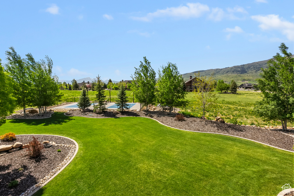 View of grassy yard featuring a mountain view