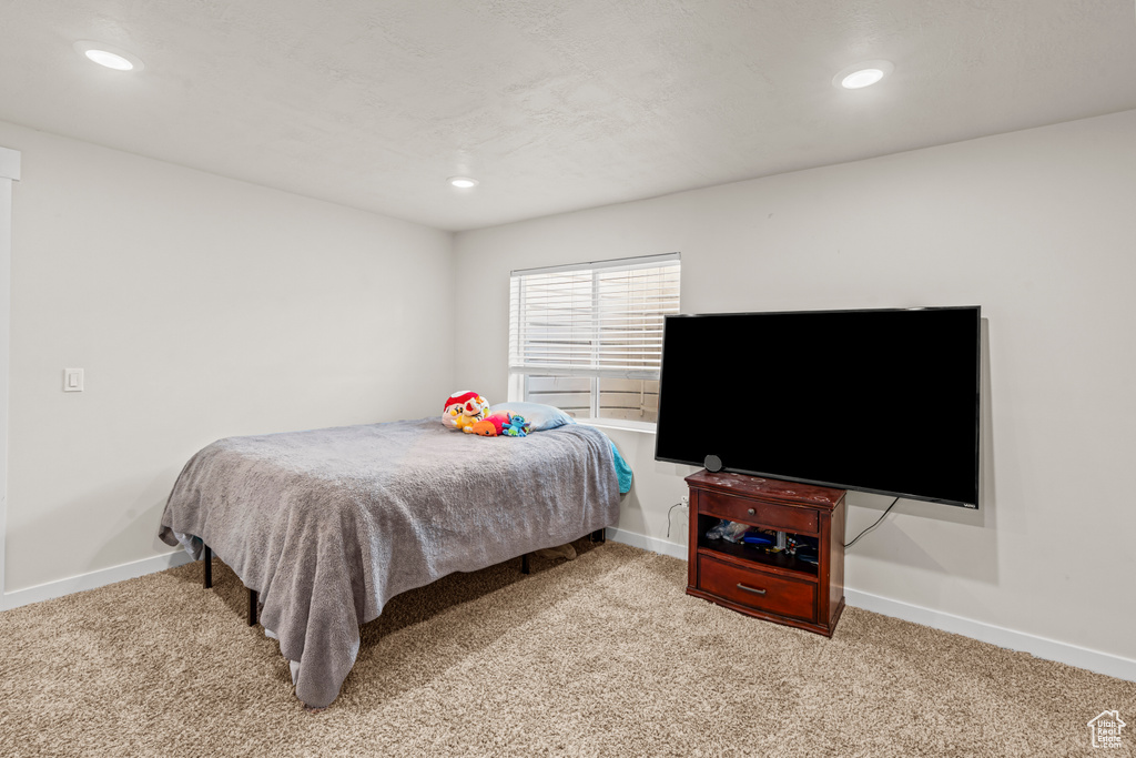 Bedroom with carpet flooring, baseboards, and recessed lighting