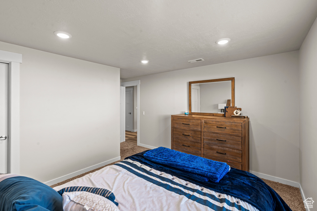 Carpeted bedroom featuring baseboards and recessed lighting
