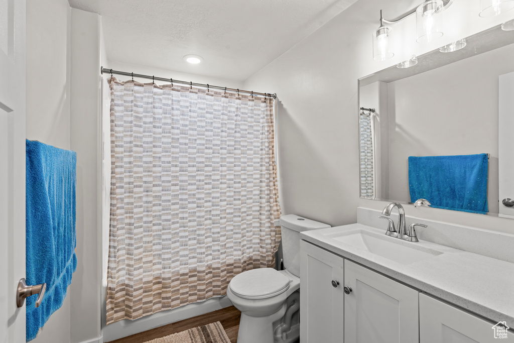 Bathroom featuring vanity, toilet, and shower / bath combo