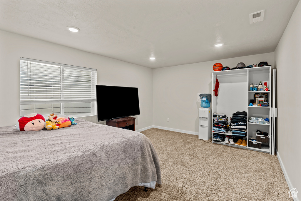 Bedroom featuring baseboards, carpet flooring, and recessed lighting