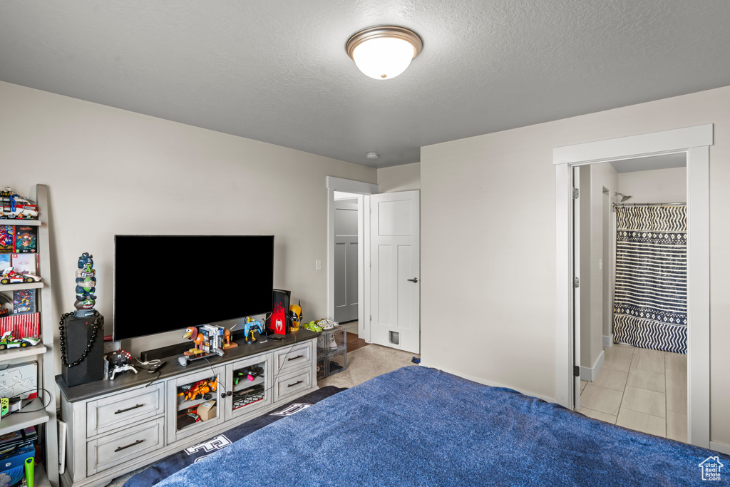 Bedroom featuring a textured ceiling and baseboards
