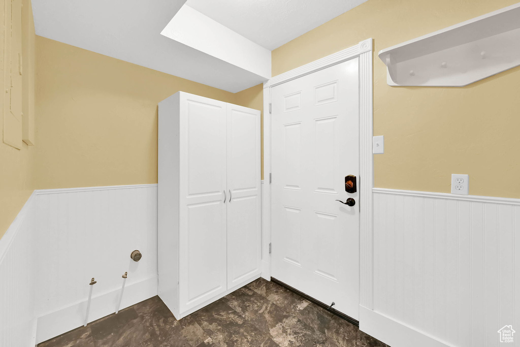 Entrance foyer featuring a wainscoted wall