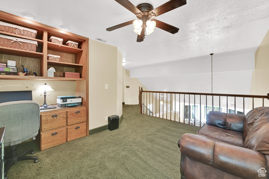 Carpeted office featuring a ceiling fan and lofted ceiling
