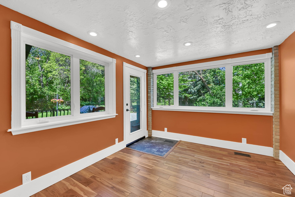 Unfurnished sunroom with plenty of natural light