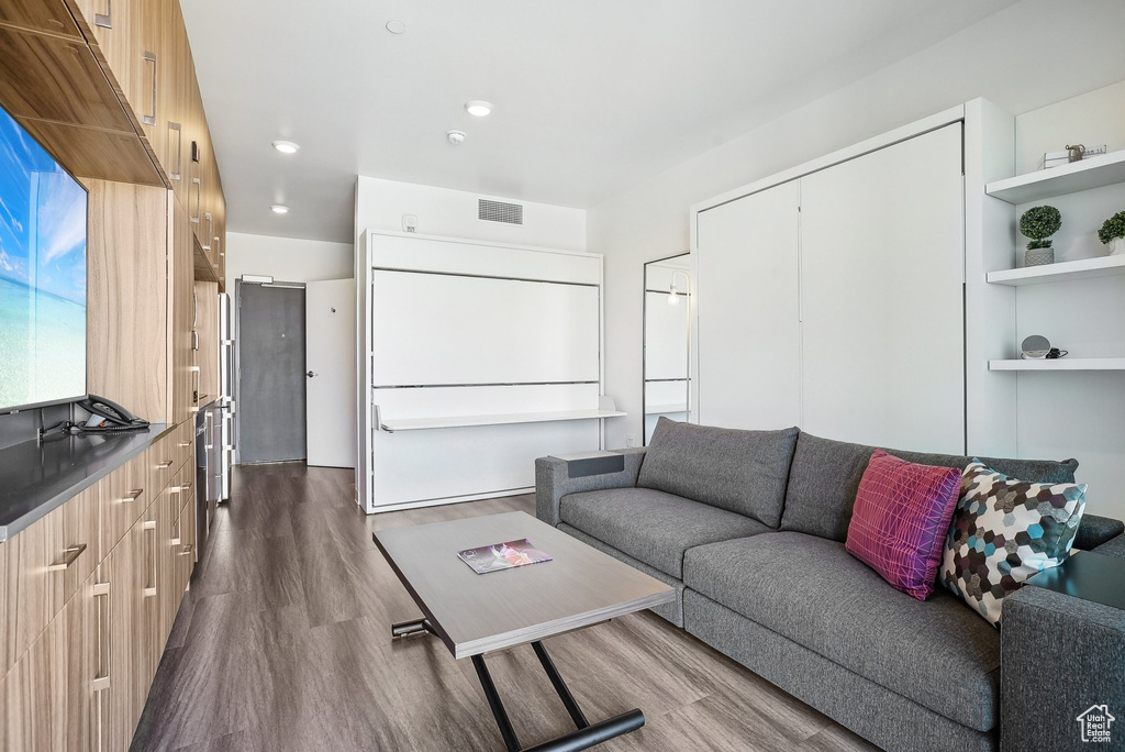 Living room featuring dark wood finished floors and recessed lighting