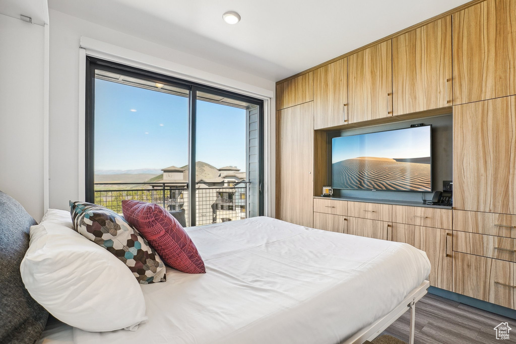 Bedroom featuring wood finished floors and access to outside