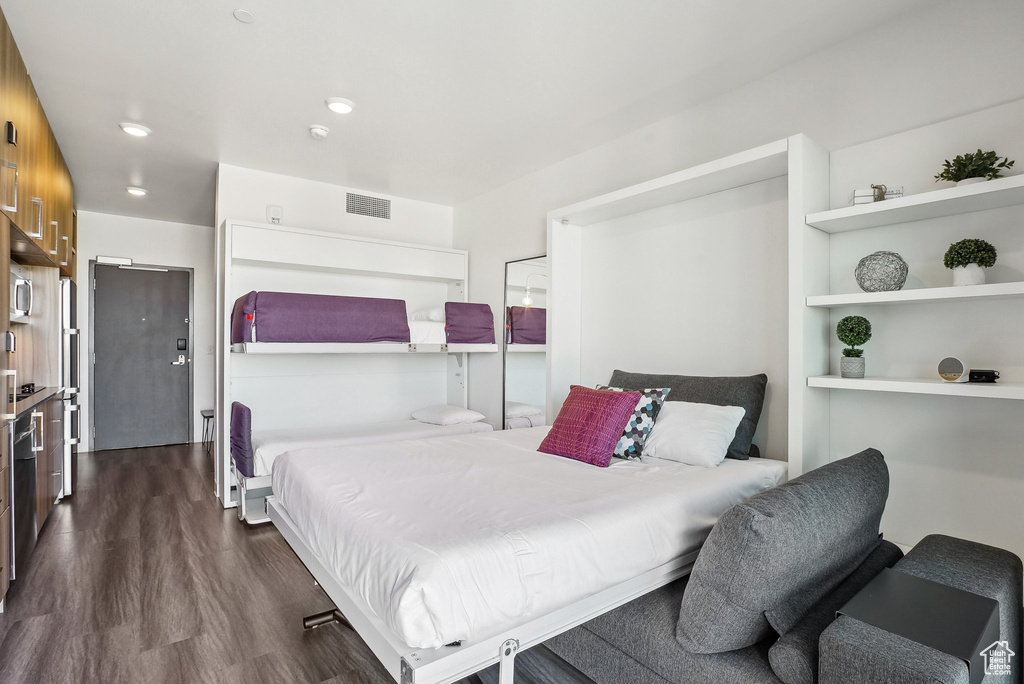 Bedroom featuring dark wood-style floors and recessed lighting