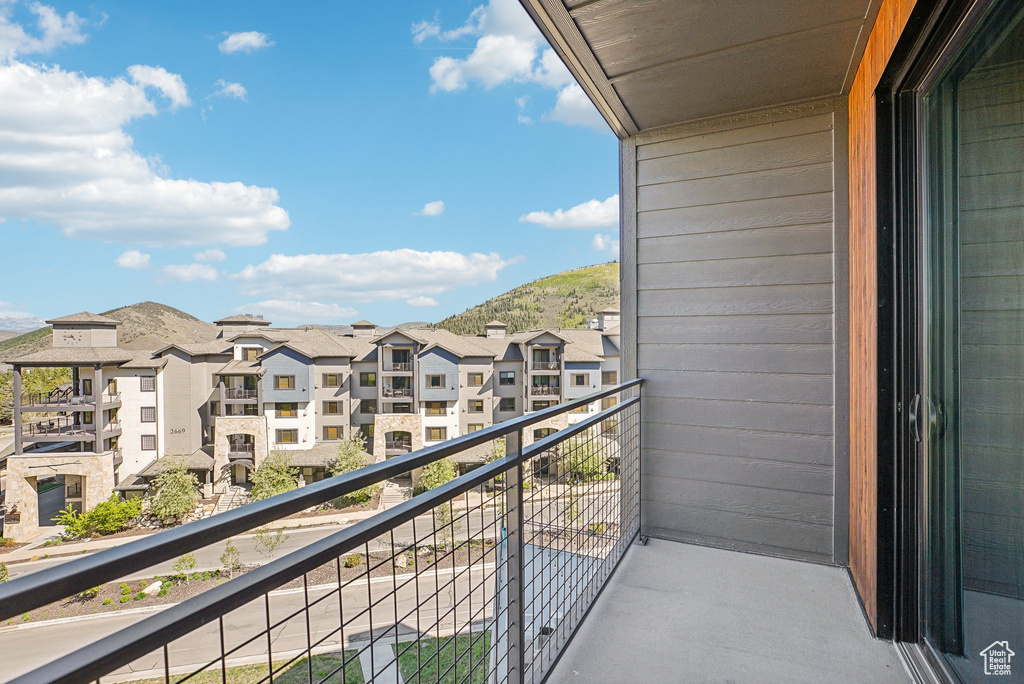 Balcony with a residential view and a mountain view