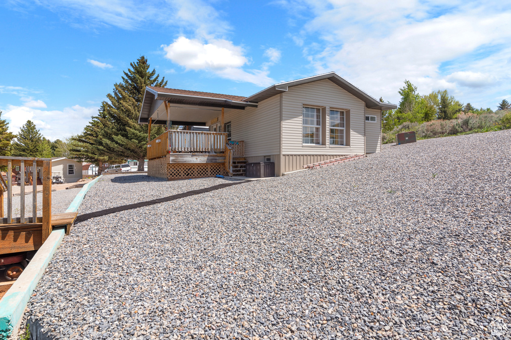 View of property exterior with covered porch and central AC unit