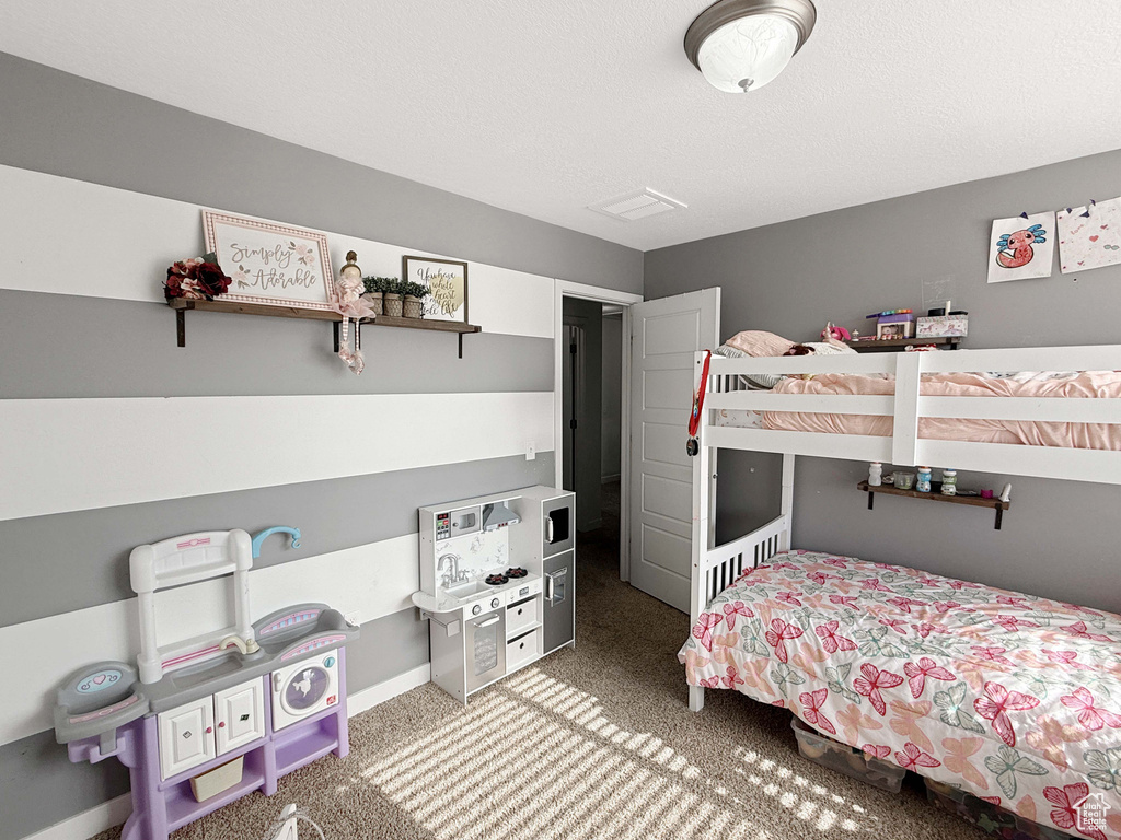 Carpeted bedroom featuring baseboards