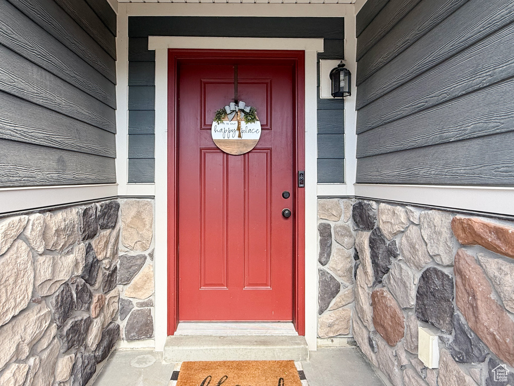 Doorway to property with stone siding